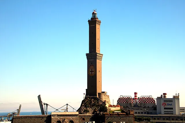 The Lanterna of Genoa, the old stone lighthouse tower, against a clear sky at the port